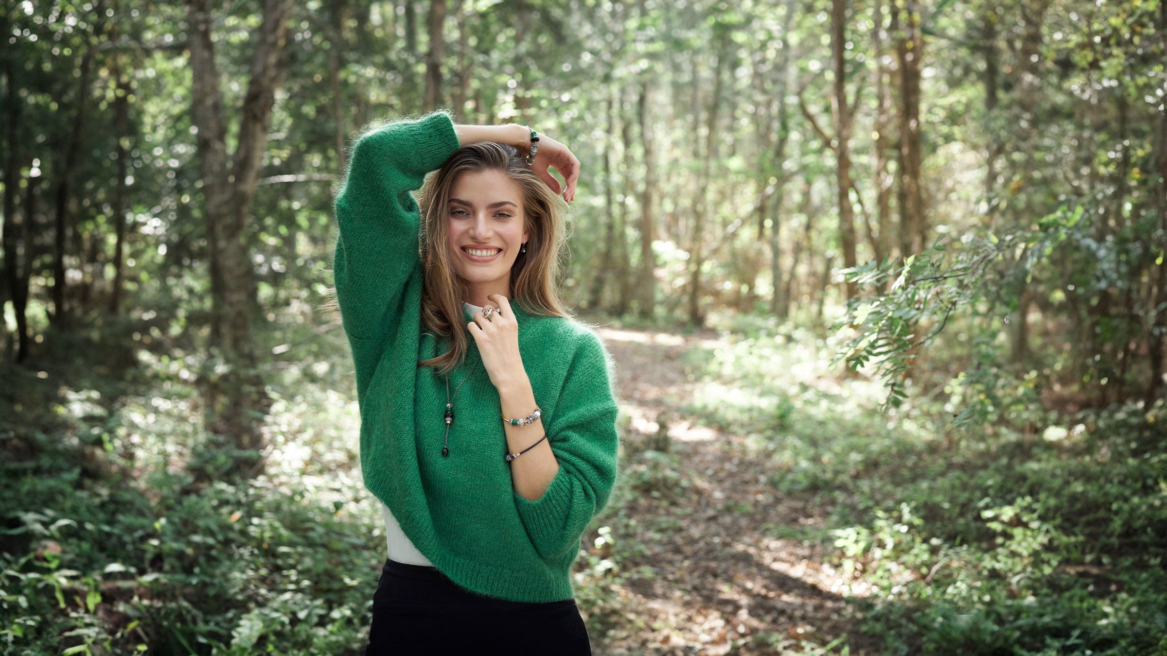 Trollbeads model standing in a forest